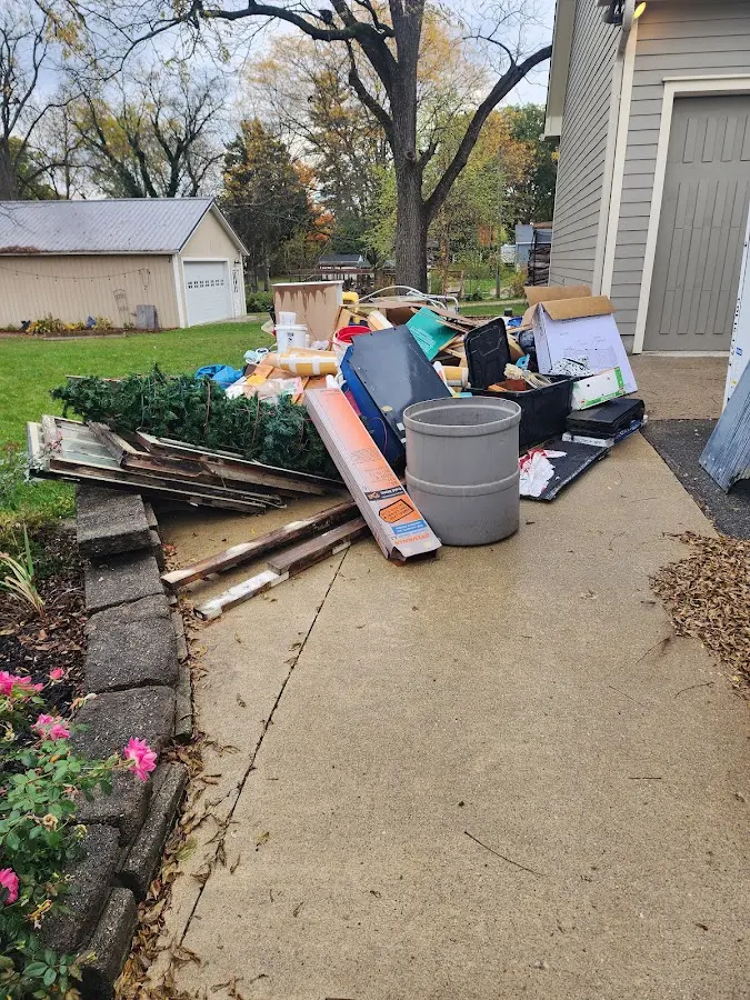 Dumpster being loaded with debris for Estate Cleanout Dumpster Rental in Hollis